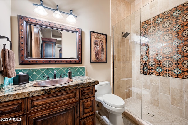 bathroom featuring vanity, a shower with shower door, and toilet