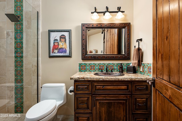 bathroom with toilet and vanity with extensive cabinet space