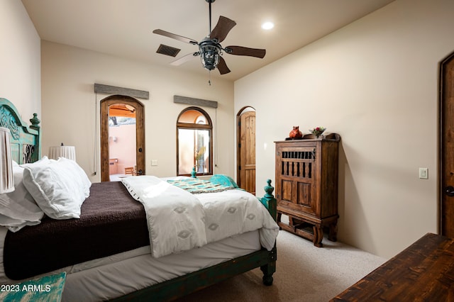 bedroom featuring ceiling fan, carpet floors, and ensuite bath