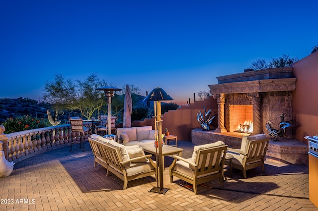 deck with a patio area and an outdoor living space with a fireplace