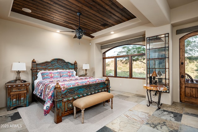 tiled bedroom featuring access to exterior, a raised ceiling, ceiling fan, and wood ceiling