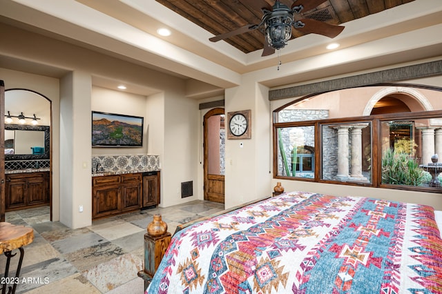 tiled bedroom featuring connected bathroom, wooden ceiling, and ceiling fan