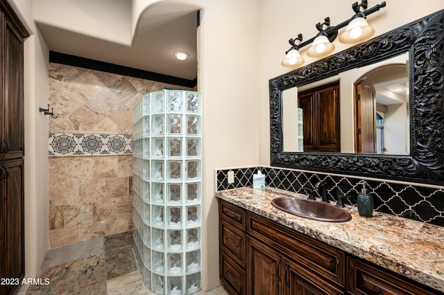 bathroom with tile floors, large vanity, tasteful backsplash, and tile walls