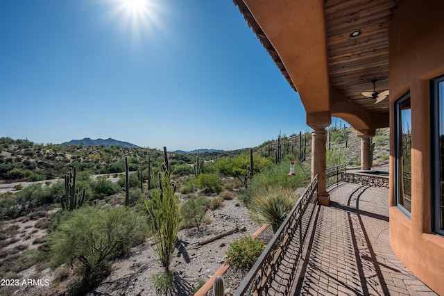 exterior space with a mountain view and ceiling fan