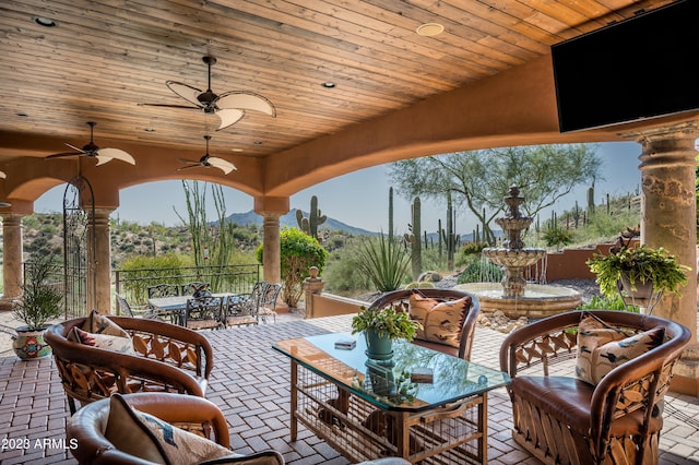 view of terrace featuring ceiling fan and a mountain view