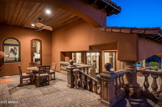 patio terrace at twilight featuring ceiling fan