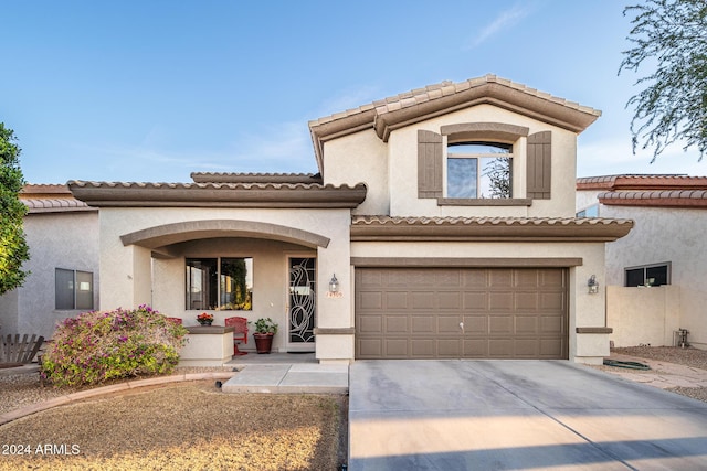 mediterranean / spanish home featuring a garage