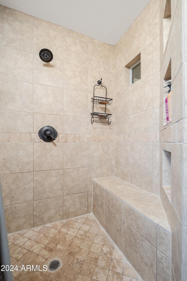 bathroom with tiled shower