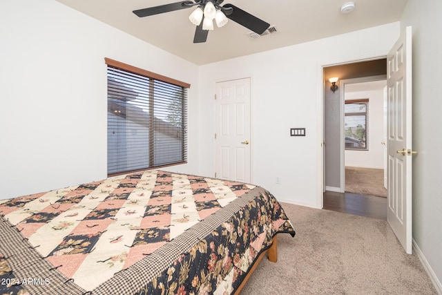 bedroom featuring ceiling fan and carpet