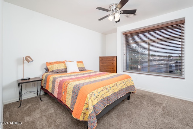 bedroom with ceiling fan and dark carpet