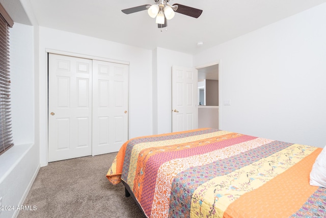 bedroom with ceiling fan, light colored carpet, and a closet