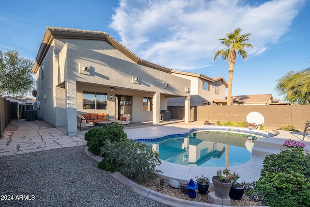 view of swimming pool with ceiling fan, central AC, outdoor lounge area, and a patio