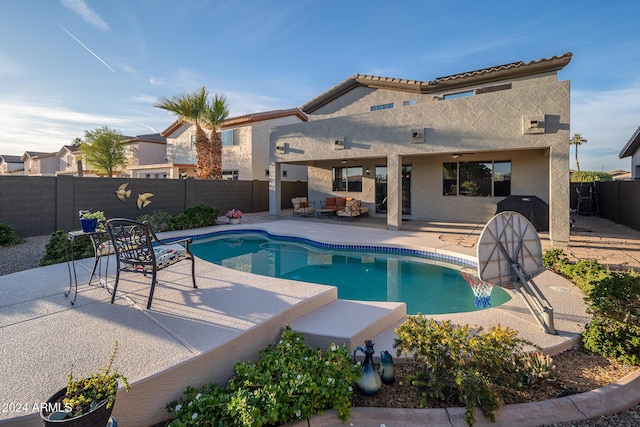 view of pool with a grill and a patio