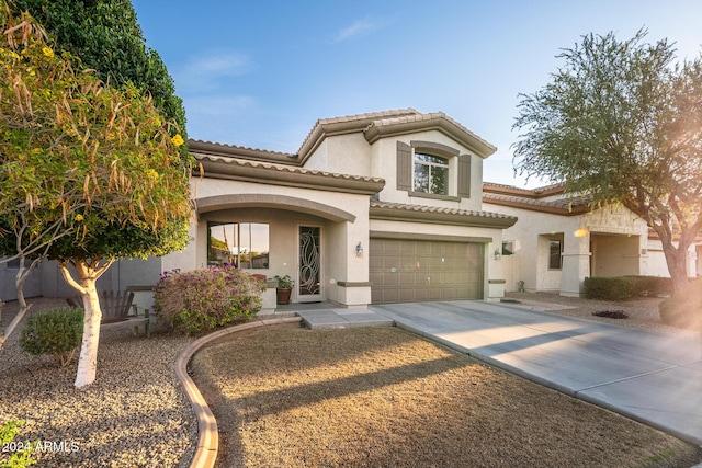 mediterranean / spanish house with a garage