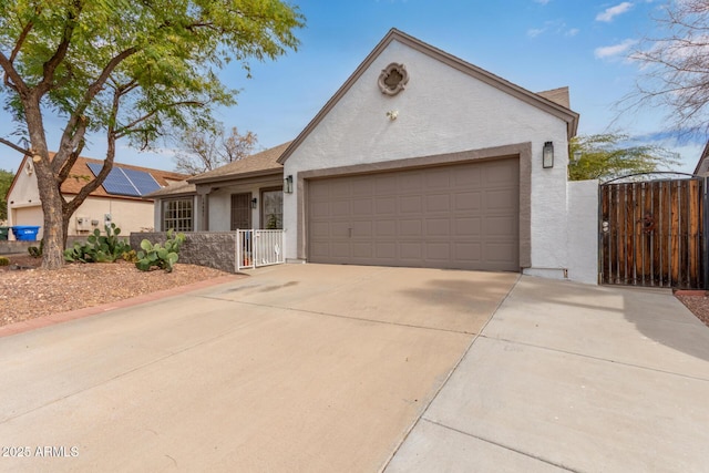 ranch-style home featuring a garage, driveway, a gate, and stucco siding