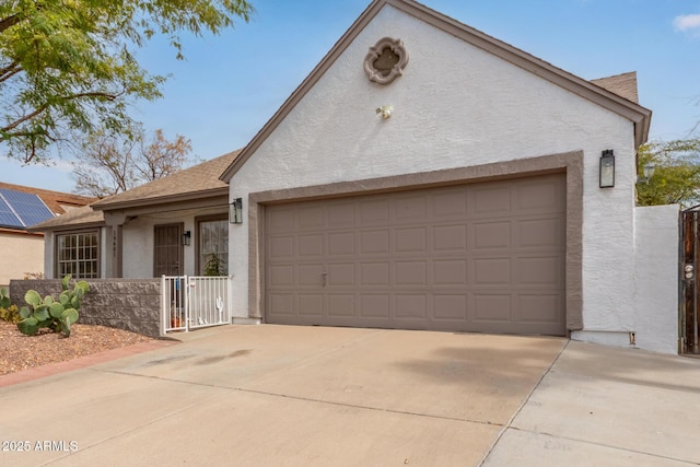 single story home featuring a garage and stucco siding