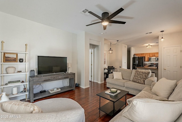 living area featuring dark wood-style floors, baseboards, visible vents, and a ceiling fan