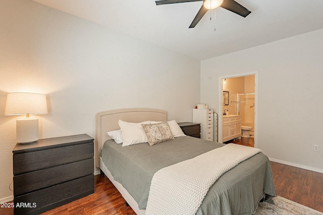 bedroom featuring dark wood-style flooring, connected bathroom, baseboards, and ceiling fan