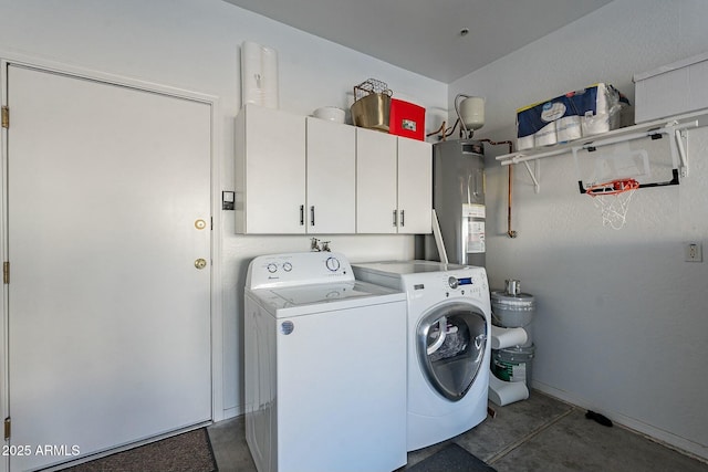 washroom with laundry area, washer and dryer, and electric water heater