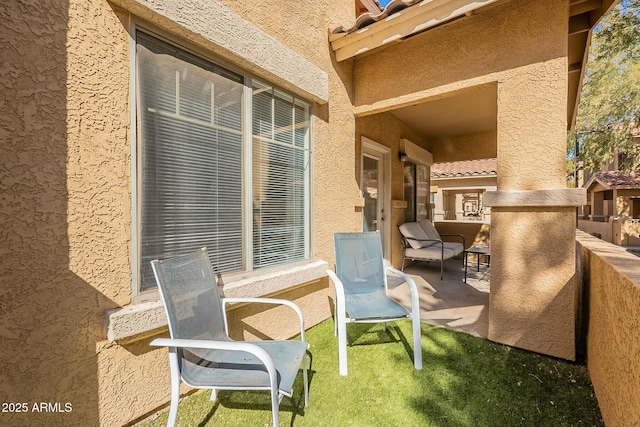 view of patio featuring a balcony