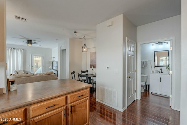 kitchen featuring visible vents, open floor plan, and dark wood-type flooring