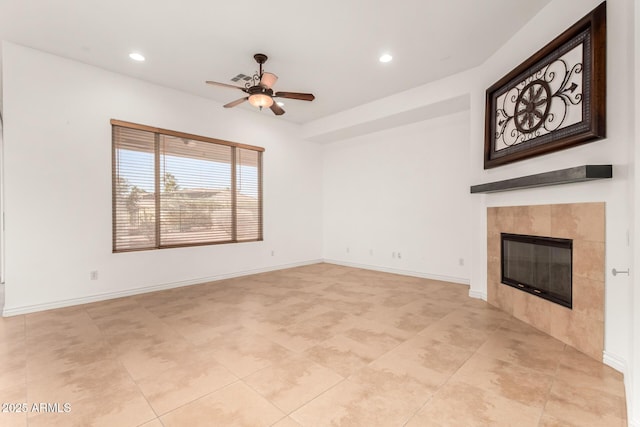 unfurnished living room featuring a tile fireplace and ceiling fan