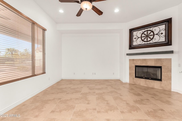 unfurnished living room with a fireplace and ceiling fan