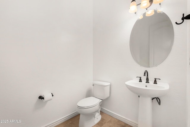 bathroom with tile patterned flooring, sink, and toilet