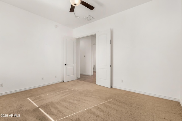 unfurnished room with ceiling fan and carpet