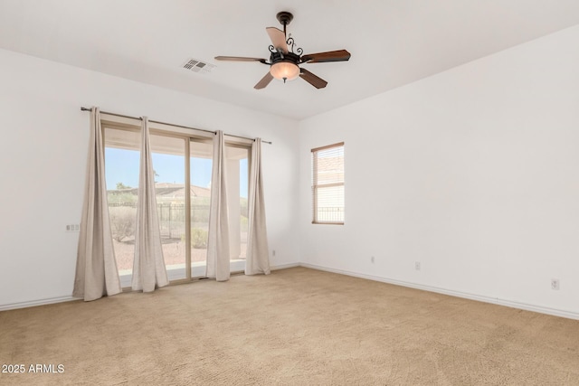 spare room featuring light carpet and ceiling fan