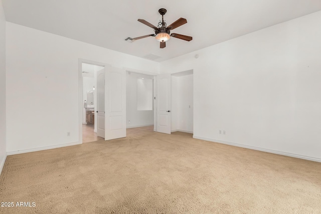 unfurnished bedroom with ceiling fan, light colored carpet, and connected bathroom