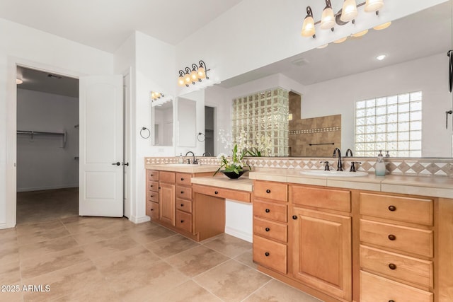 bathroom featuring tile patterned floors, vanity, and a shower