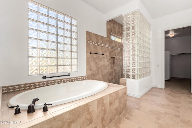 bathroom with tile patterned floors, a healthy amount of sunlight, and independent shower and bath