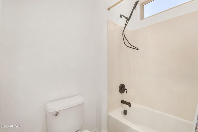 bathroom featuring washtub / shower combination and toilet