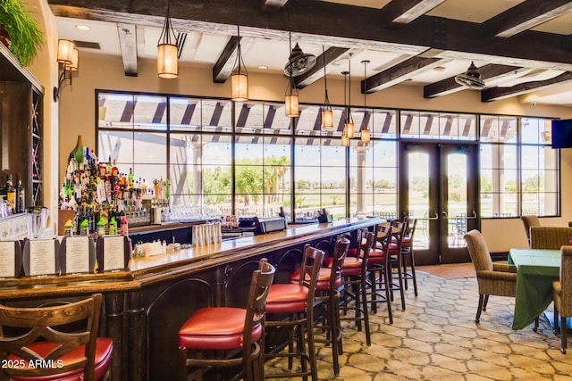 bar featuring beamed ceiling and french doors