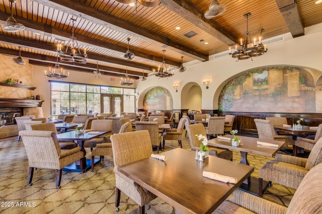 dining area with beam ceiling, a chandelier, and wooden ceiling