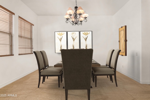 carpeted dining space with a chandelier