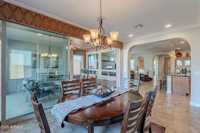 dining space featuring crown molding, a chandelier, and light tile patterned flooring