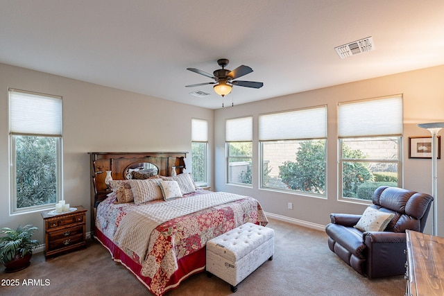 carpeted bedroom with ceiling fan and multiple windows