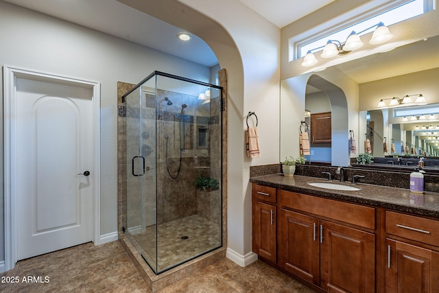 bathroom featuring an enclosed shower and vanity