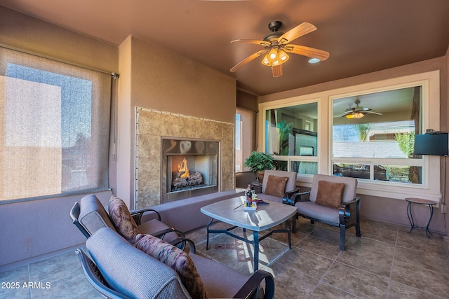 sunroom / solarium with ceiling fan and an outdoor fireplace