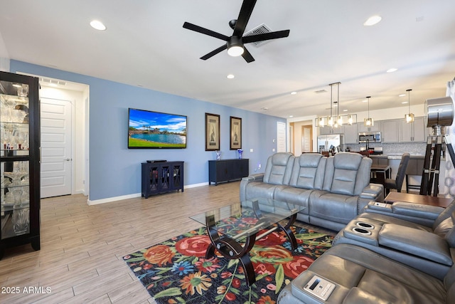 19560 W Valle Vista Way, Litchfield Park, AZ 85340 - living area with recessed lighting, baseboards, light wood-style floors, and ceiling fan with notable chandelier