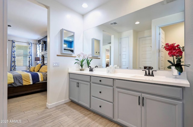 19560 W Valle Vista Way, Litchfield Park, AZ 85340 - full bath featuring wood finished floors, double vanity, baseboards, ensuite bath, and visible vents