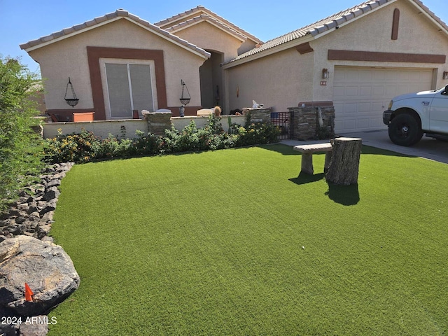 view of front facade featuring a garage and a front lawn