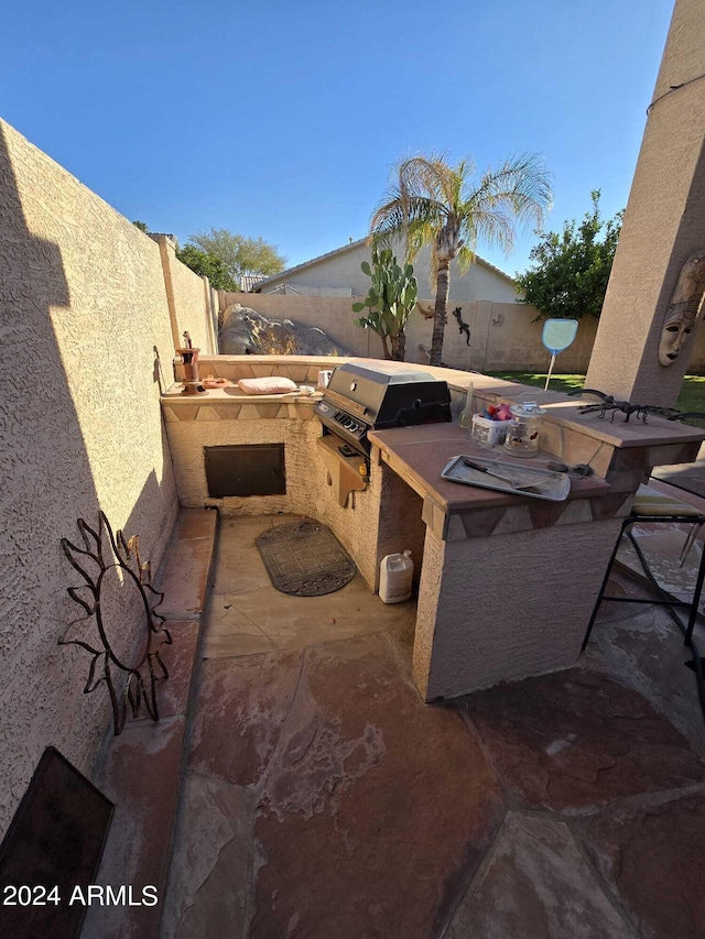 view of patio with area for grilling and exterior kitchen