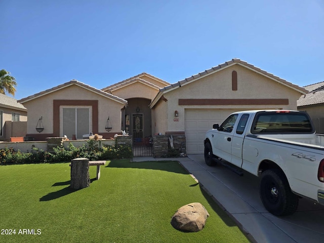 ranch-style house with a garage and a front lawn