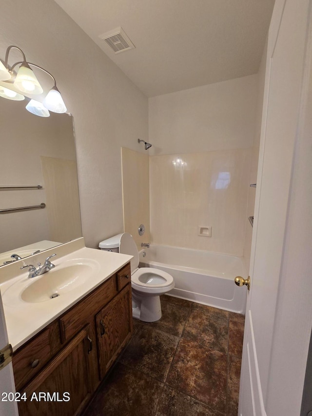 full bathroom featuring washtub / shower combination, vanity, and toilet