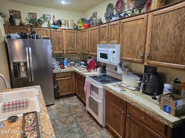 kitchen featuring sink and white appliances