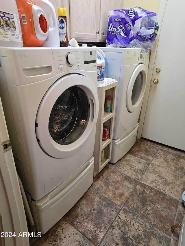 laundry room featuring cabinets and separate washer and dryer