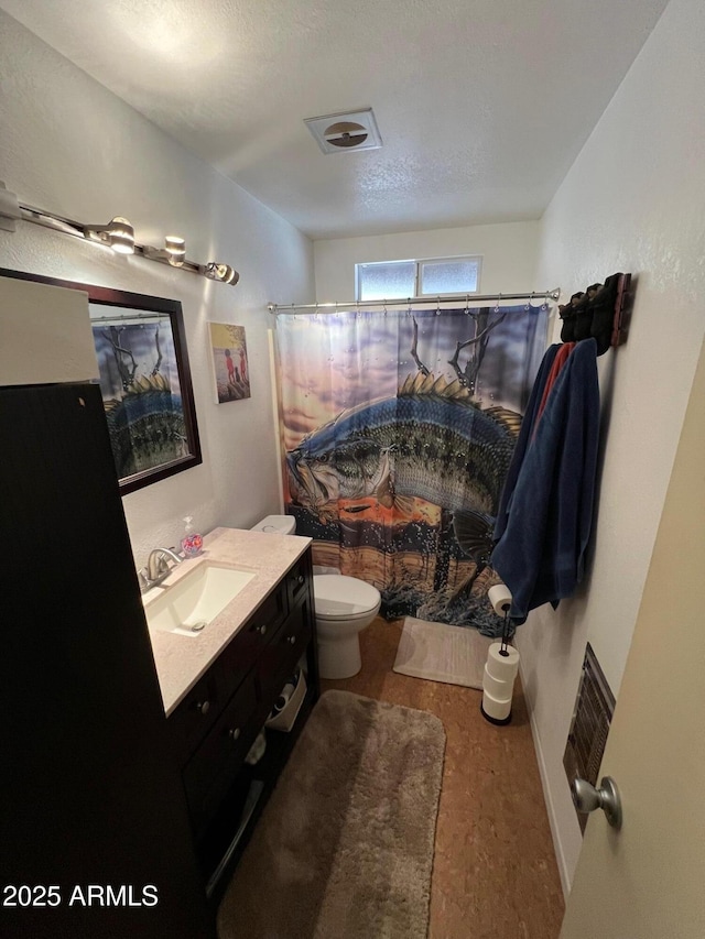 bathroom featuring toilet, wood-type flooring, a textured ceiling, vanity, and a shower with shower curtain